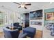 Comfortable living room with an electric fireplace, large TV, blue leather chairs, and lots of light at 101 Caleb Ct, Ladson, SC 29456