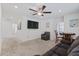 Spacious living room with a large sectional sofa, TV, ceiling fan, and neutral carpet at 101 Caleb Ct, Ladson, SC 29456