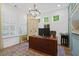 Well-lit office features plantation shutters, a chandelier, and a charming color scheme at 101 Caleb Ct, Ladson, SC 29456