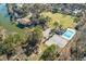 Aerial view featuring the community pool, tennis courts, lake, and playground amidst lush greenery at 102 Ashborough Ave, Summerville, SC 29485