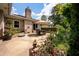 Well-maintained back patio features an outdoor dining set, lush garden, and convenient access to the home at 102 Ashborough Ave, Summerville, SC 29485