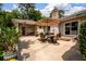 Spacious back patio featuring an outdoor dining set, brick exterior, and ample space for entertaining at 102 Ashborough Ave, Summerville, SC 29485