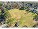 Aerial view of a large, well-maintained ball field surrounded by trees and homes at 102 Ashborough Ave, Summerville, SC 29485