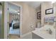 Hall bathroom featuring a white vanity and sink, with a view to a guest bedroom at 102 Ashborough Ave, Summerville, SC 29485