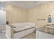Bathroom features a soaking tub, single vanity, granite countertops and modern fixtures at 102 Ashborough Ave, Summerville, SC 29485