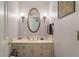 Powder room featuring a white vanity with gold fixtures and decorative lighting at 102 Ashborough Ave, Summerville, SC 29485