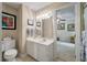 Bathroom with white vanity, decorative lighting and mirror, and a view to an office at 102 Ashborough Ave, Summerville, SC 29485