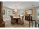 Dining room showcases a wood table, stylish chandelier, and views of the front yard at 102 Ashborough Ave, Summerville, SC 29485