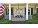 Inviting front porch with classic white columns, brick accents, and charming floral arrangements at 102 Ashborough Ave, Summerville, SC 29485