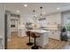 Bright kitchen featuring white cabinets, a center island with seating, and modern stainless-steel appliances at 102 Ashborough Ave, Summerville, SC 29485
