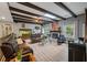 Spacious living room with wood-beamed ceiling, a brick fireplace, and comfortable leather sofas at 102 Ashborough Ave, Summerville, SC 29485