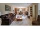 Cozy living room and dining area featuring a brown sofa, wooden furniture, and carpet at 102 Ashborough Ave, Summerville, SC 29485