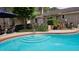 Inviting backyard pool with tiled trim, brick patio, lush greenery, and partial view of the brick home at 102 Ashborough Ave, Summerville, SC 29485