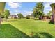 Expansive backyard with lush green grass, mature trees, and a charming pergola at 1027 E Recess Rd, Hanahan, SC 29410
