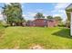 View of the large backyard, brick house, and wooden pergola at 1027 E Recess Rd, Hanahan, SC 29410