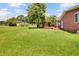 Spacious backyard with green grass, mature trees, and a charming covered pergola at 1027 E Recess Rd, Hanahan, SC 29410