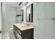Bright bathroom featuring a double sink vanity, decorative mirrors, and neutral-toned walls at 1027 E Recess Rd, Hanahan, SC 29410