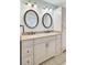 Bathroom vanity with double sinks, bronze fixtures, granite counters, and tile flooring at 1027 E Recess Rd, Hanahan, SC 29410