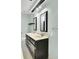 Bright bathroom featuring a double sink vanity, decorative mirrors, and neutral-toned walls at 1027 E Recess Rd, Hanahan, SC 29410