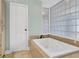 Bathroom with a soaking tub and glass block window at 1027 E Recess Rd, Hanahan, SC 29410