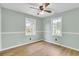 Bedroom with ceiling fan, bright windows, and wood-look flooring at 1027 E Recess Rd, Hanahan, SC 29410