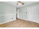 Bedroom with double closet, ceiling fan, and wood-look flooring at 1027 E Recess Rd, Hanahan, SC 29410