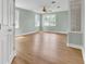 Bright bedroom with ceiling fan, light paint, and wood-look flooring at 1027 E Recess Rd, Hanahan, SC 29410