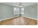 Bright bedroom featuring three windows with a ceiling fan and wood-look floors at 1027 E Recess Rd, Hanahan, SC 29410