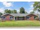 Inviting brick home featuring classic architectural design and a well-manicured lawn at 1027 E Recess Rd, Hanahan, SC 29410