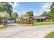 Charming brick home with mature palm trees and a two-car garage at 1027 E Recess Rd, Hanahan, SC 29410