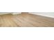 Close up of new luxury vinyl plank flooring with white baseboards at 1027 E Recess Rd, Hanahan, SC 29410