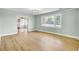 Living room with luxury vinyl plank flooring and large window, offering natural light at 1027 E Recess Rd, Hanahan, SC 29410