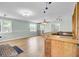 Expansive room featuring natural light, luxury vinyl plank flooring and a custom bar at 1027 E Recess Rd, Hanahan, SC 29410
