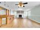 Open living space featuring a brick fireplace, built-in shelving, and luxury vinyl plank flooring at 1027 E Recess Rd, Hanahan, SC 29410