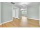 Bright living room area featuring luxury vinyl plank flooring and an open-concept design at 1027 E Recess Rd, Hanahan, SC 29410