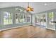 Bright living room featuring hardwood floors, large windows, and a sliding glass door leading to the backyard at 1027 E Recess Rd, Hanahan, SC 29410