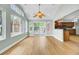 Bright living room featuring hardwood floors, large windows, and a sliding glass door leading to the backyard at 1027 E Recess Rd, Hanahan, SC 29410