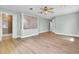 Spacious main bedroom with wood flooring, ceiling fan, and an ensuite bathroom behind privacy glass at 1027 E Recess Rd, Hanahan, SC 29410