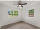 Bedroom boasts natural light, a ceiling fan, and two windows offering neighborhood views at 105 Bermuda Ct, Summerville, SC 29485
