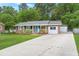 Charming brick home with a blue front door, manicured lawn, and long driveway at 105 Bermuda Ct, Summerville, SC 29485