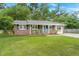 Charming brick home with a well-manicured lawn and a welcoming light blue front door at 105 Bermuda Ct, Summerville, SC 29485