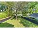 Overhead view of the home's fenced backyard with mature trees and a lush green lawn at 1055 Royalist Rd, Mount Pleasant, SC 29464