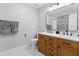 Bright bathroom featuring a double vanity, a large mirror, and modern fixtures at 1055 Royalist Rd, Mount Pleasant, SC 29464