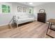 Cozy bedroom with natural light, wood floors, daybed, and a traditional wooden dresser at 1055 Royalist Rd, Mount Pleasant, SC 29464