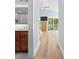 Light-filled hallway with wood floors leads to a bedroom with balcony access and a stylish bathroom with modern fixtures at 1055 Royalist Rd, Mount Pleasant, SC 29464