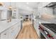 Stylish kitchen featuring white cabinets, stainless appliances, large island, a gas range and open to the Gathering room at 1055 Royalist Rd, Mount Pleasant, SC 29464