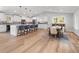 Bright, open-concept kitchen featuring a large island with seating, stainless steel appliances, and light wood flooring at 1055 Royalist Rd, Mount Pleasant, SC 29464