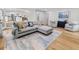 Inviting living room featuring a large sectional sofa, wood floors, and an open layout connecting to the kitchen at 1055 Royalist Rd, Mount Pleasant, SC 29464