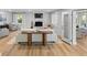 Cozy living room with a white brick fireplace, a comfortable sectional, and hardwood floors, open to the kitchen at 1055 Royalist Rd, Mount Pleasant, SC 29464