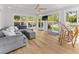 Bright sunroom-style living room with hardwood floors, coffered ceiling, and backyard views at 1055 Royalist Rd, Mount Pleasant, SC 29464